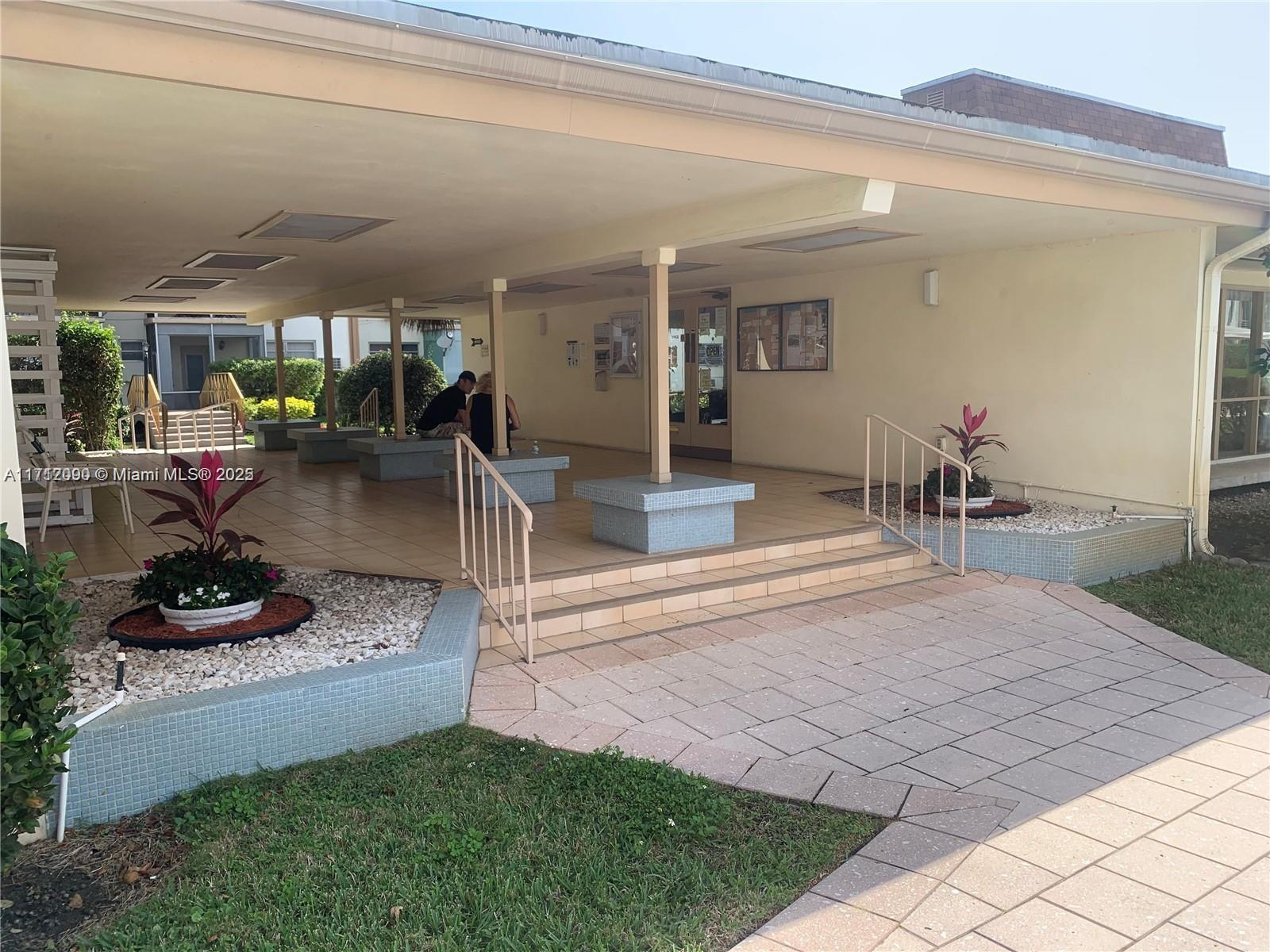 1395 Northeast 167th Street, Unit 209 Miami, FL 33162 - Photo 11 of 28 a view of a porch with dining table and chairs