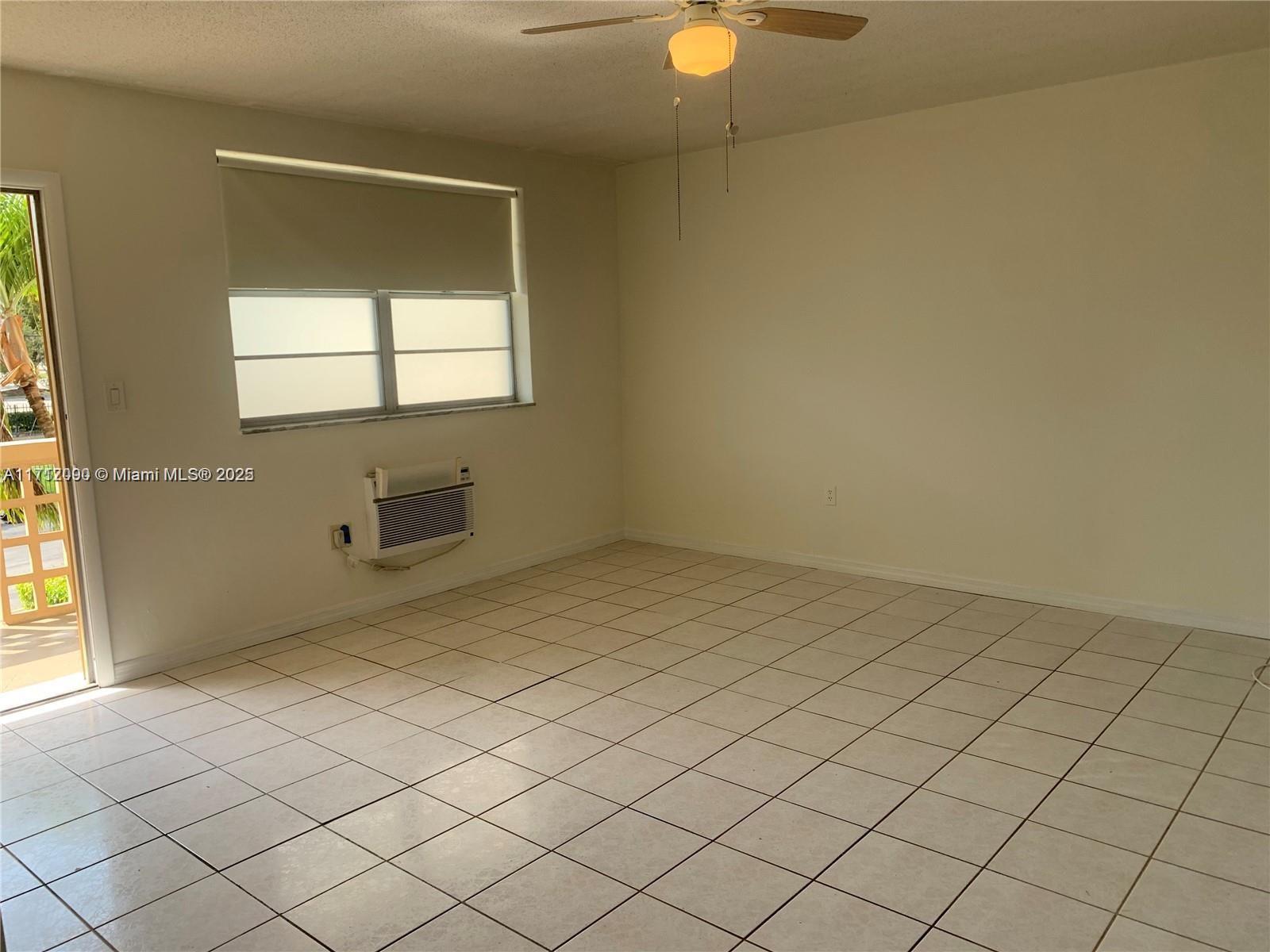 1395 Northeast 167th Street, Unit 209 Miami, FL 33162 - Photo 18 of 28 an empty room with windows