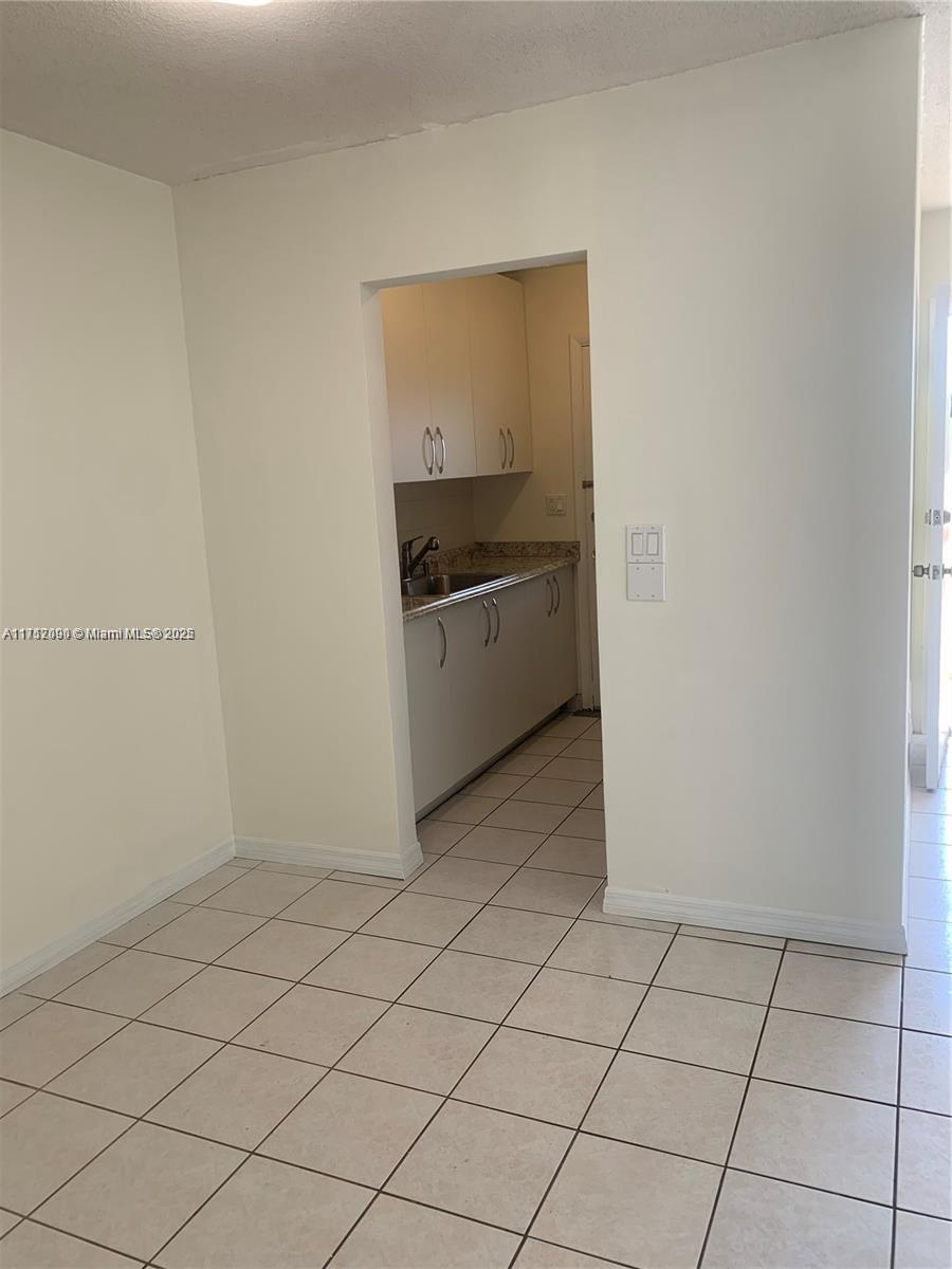 1395 Northeast 167th Street, Unit 209 Miami, FL 33162 - Photo 21 of 28 a kitchen with a sink