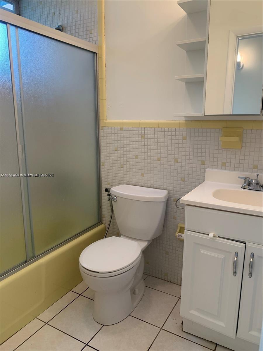1395 Northeast 167th Street, Unit 209 Miami, FL 33162 - Photo 26 of 28 a bathroom with a toilet sink and a shower