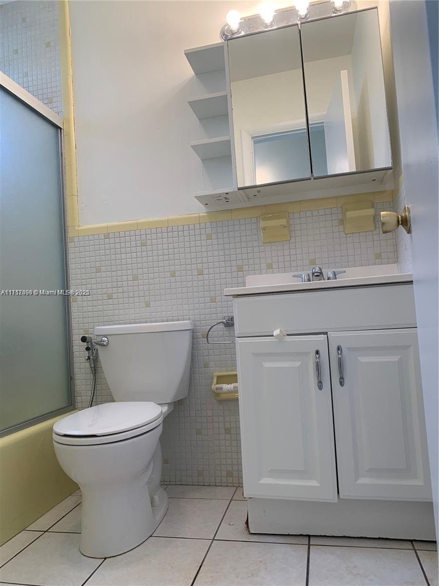 1395 Northeast 167th Street, Unit 209 Miami, FL 33162 - Photo 27 of 28 a bathroom with a toilet and a sink