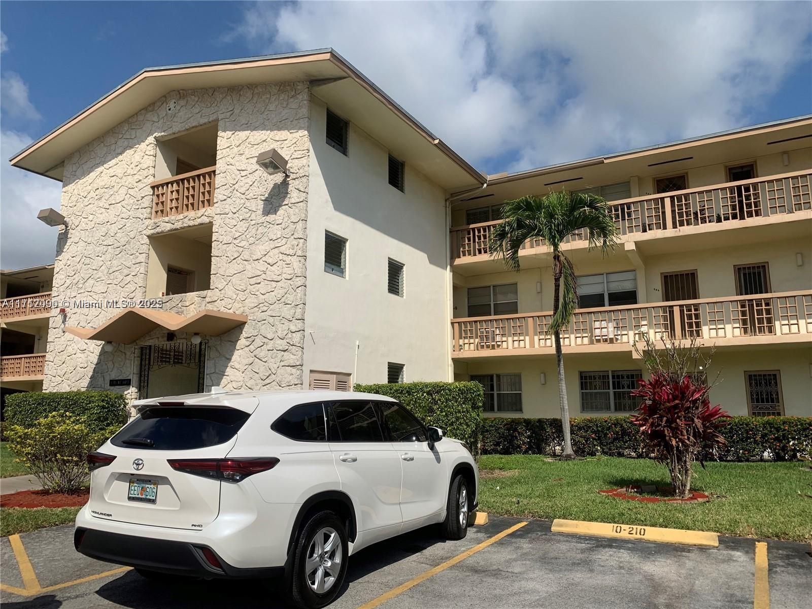 1395 Northeast 167th Street, Unit 209 Miami, FL 33162 - Photo 4 of 28 a view of multiple house with yard