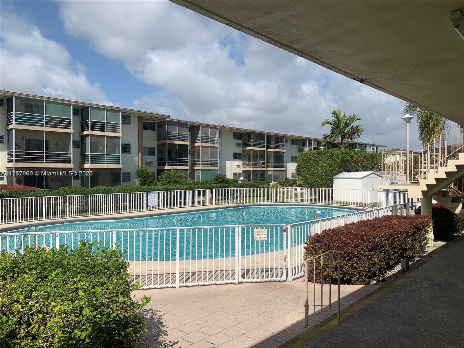 1395 Northeast 167th Street, Unit 209 Miami, FL 33162 - Photo 6 of 28 a view of a house with a porch