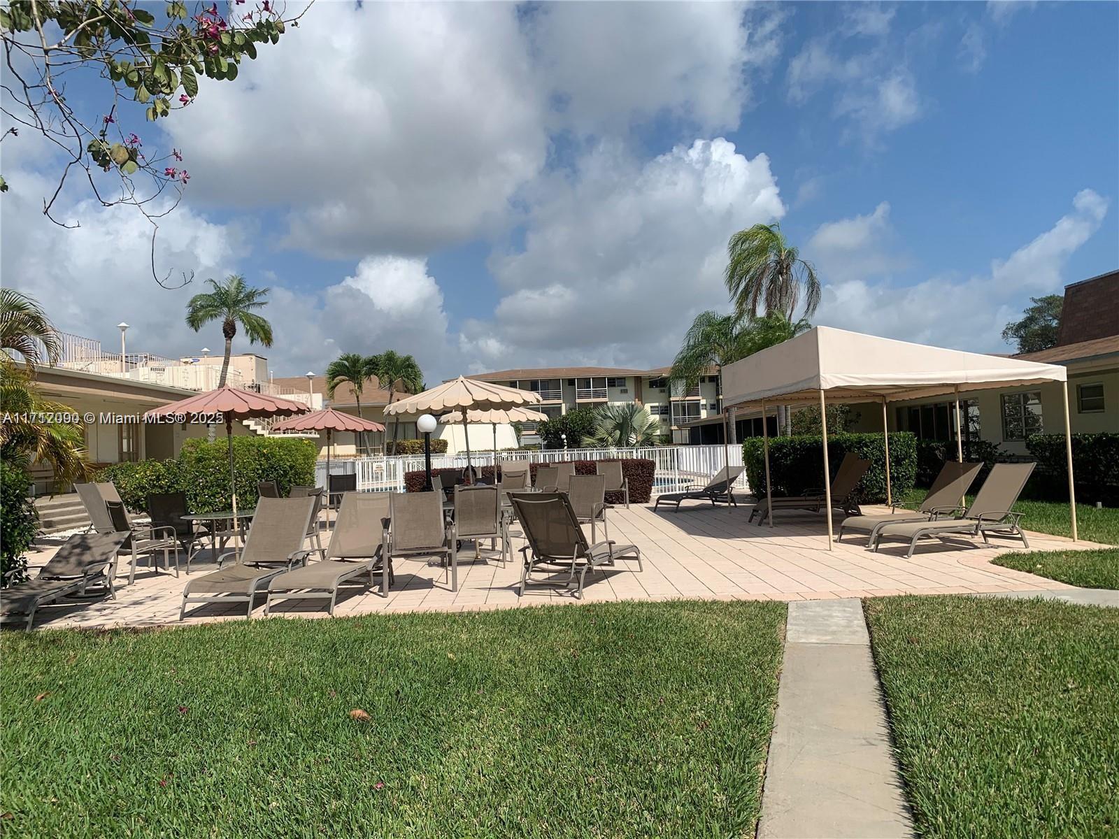 1395 Northeast 167th Street, Unit 209 Miami, FL 33162 - Photo 7 of 28 a view of a park with swings and slides