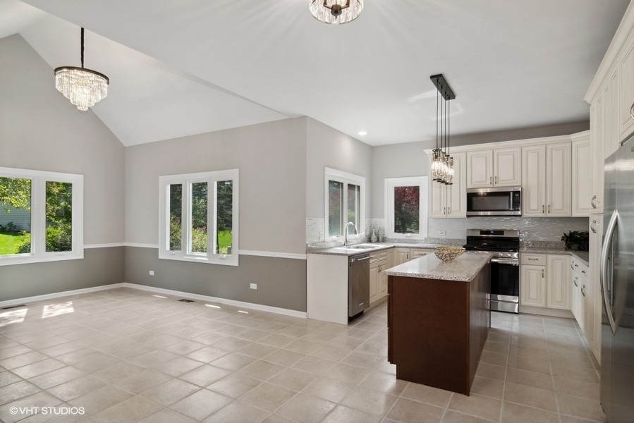 2616 Wendy Road Naperville, IL 60565 - Photo 9 of 29 a kitchen with stainless steel appliances granite countertop a stove oven and a sink with granite countertops