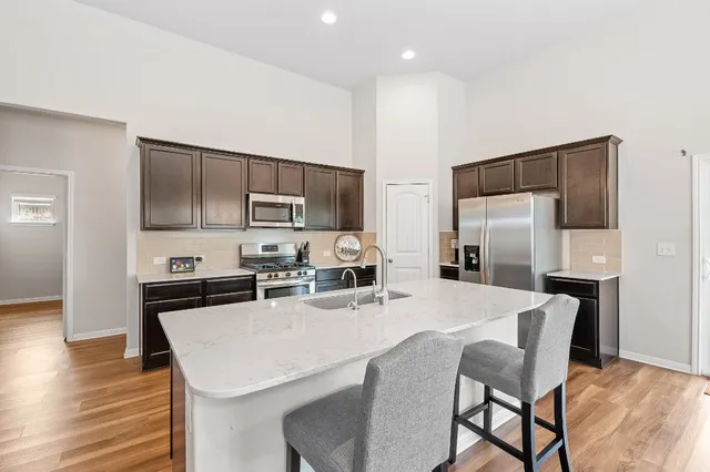 a kitchen with kitchen island a refrigerator stove microwave and cabinets