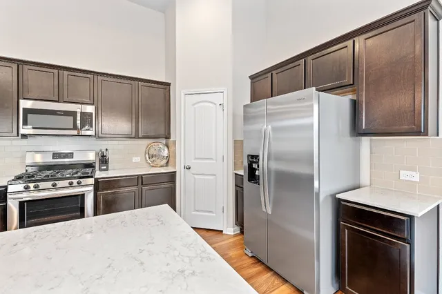 a kitchen with a refrigerator stove and microwave
