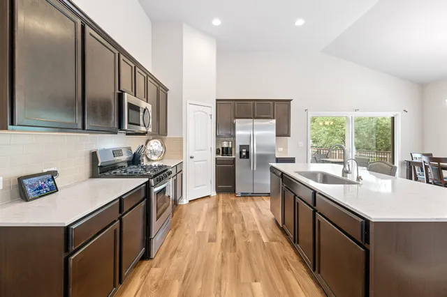 a kitchen with a stove sink and cabinets
