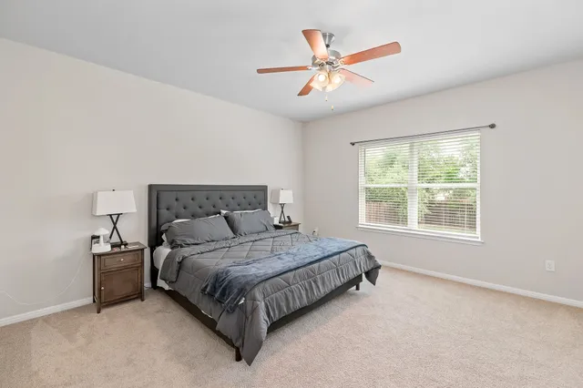a bed sitting in a bedroom next to a window