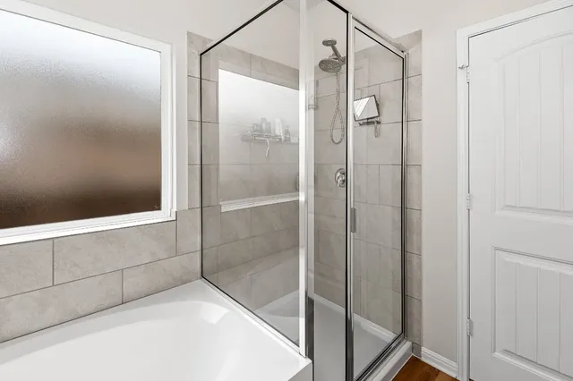 a bathroom with a glass shower door