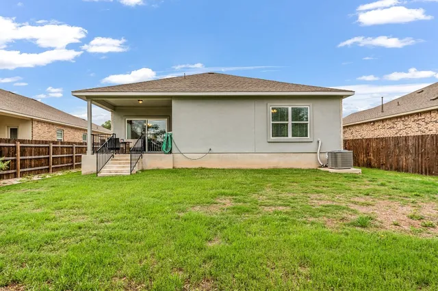 a view of a backyard with plants and a garden