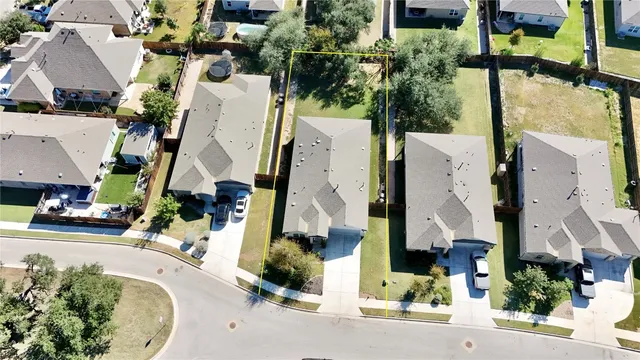 an aerial view of a house with a swimming pool and outdoor seating