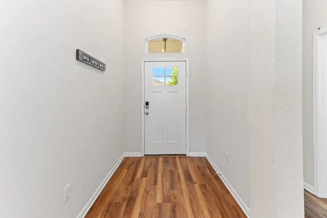 a view of a hallway with wooden floor