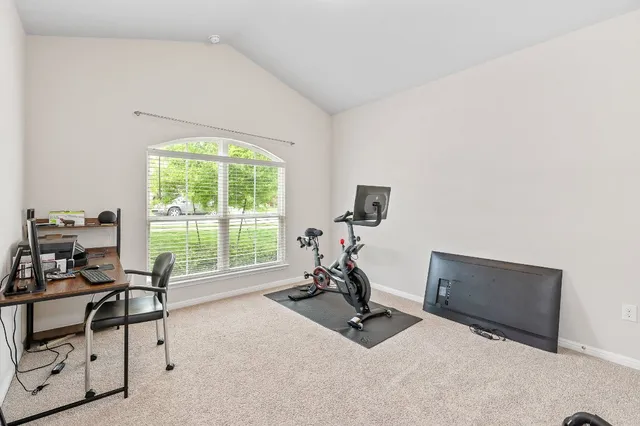 a view of a room with gym equipment and a large window