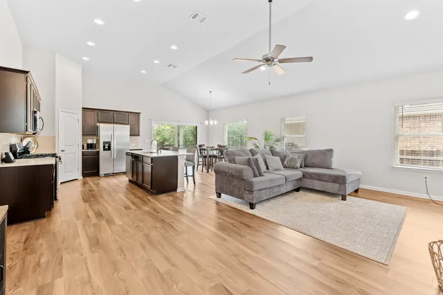 a living room with furniture wooden floor and a window