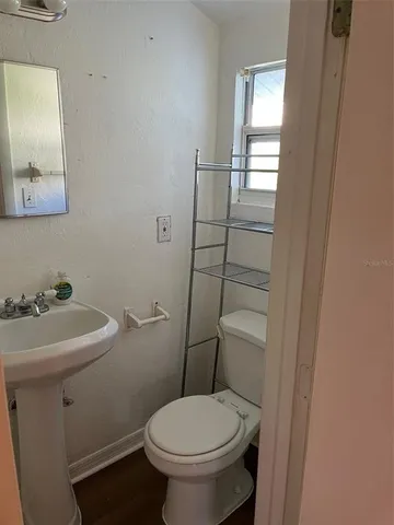 a bathroom with a sink toilet and mirror