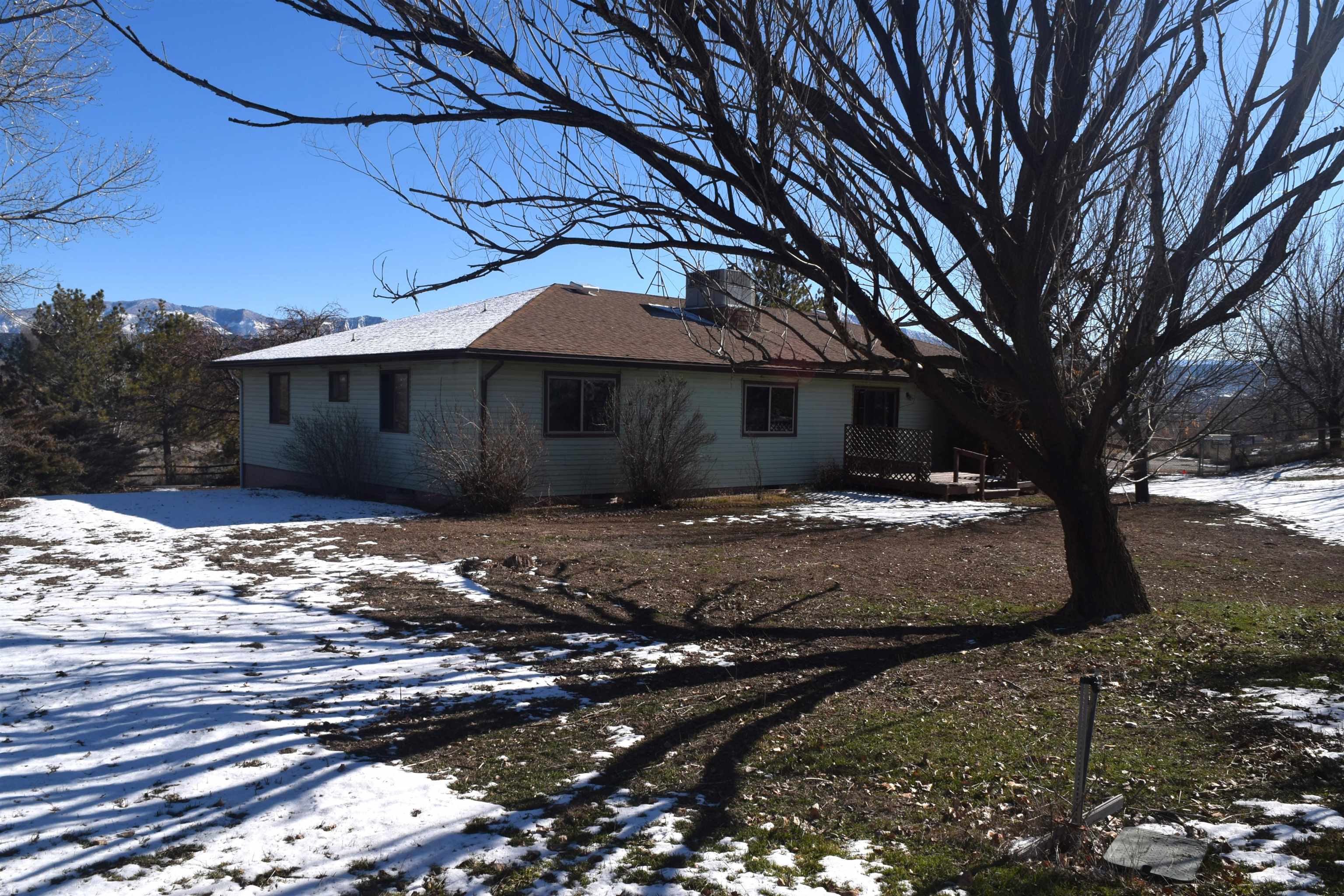 4399 44 Road De Beque, CO 81630 - Photo 2 of 31 a view of a house with a yard tree and wooden fence