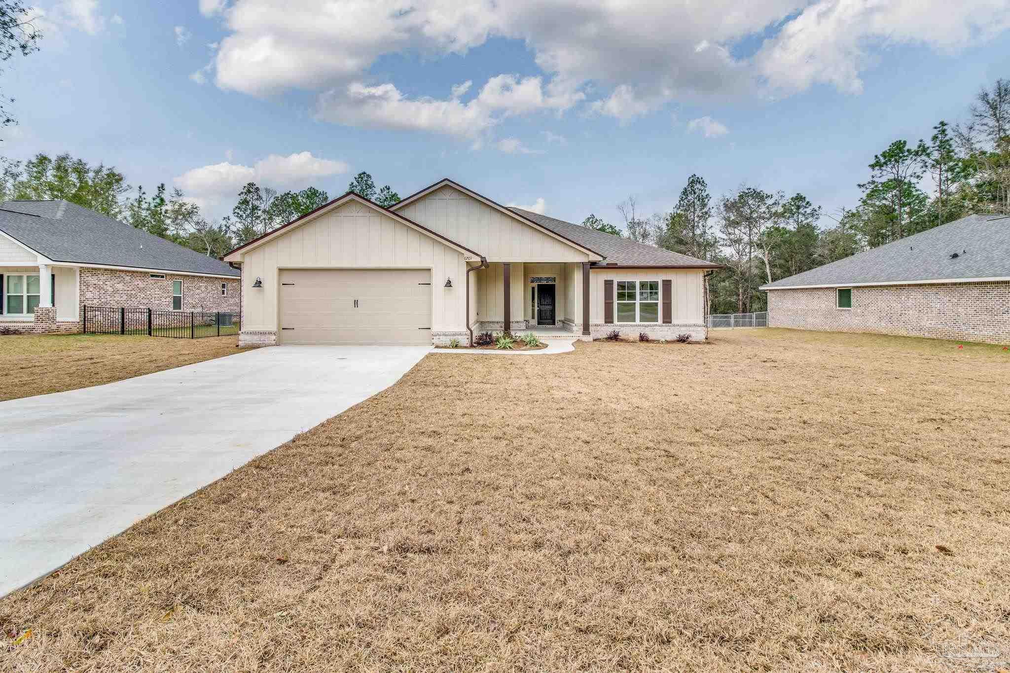 4310 Watkins Street Pace, FL 32571 - Photo 2 of 58 front view of a house with a yard