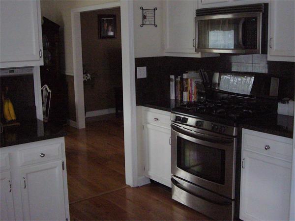 32 Stonegate Road Chelmsford, MA 01824 - Photo 3 of 20 a kitchen with granite countertop a stove and a microwave
