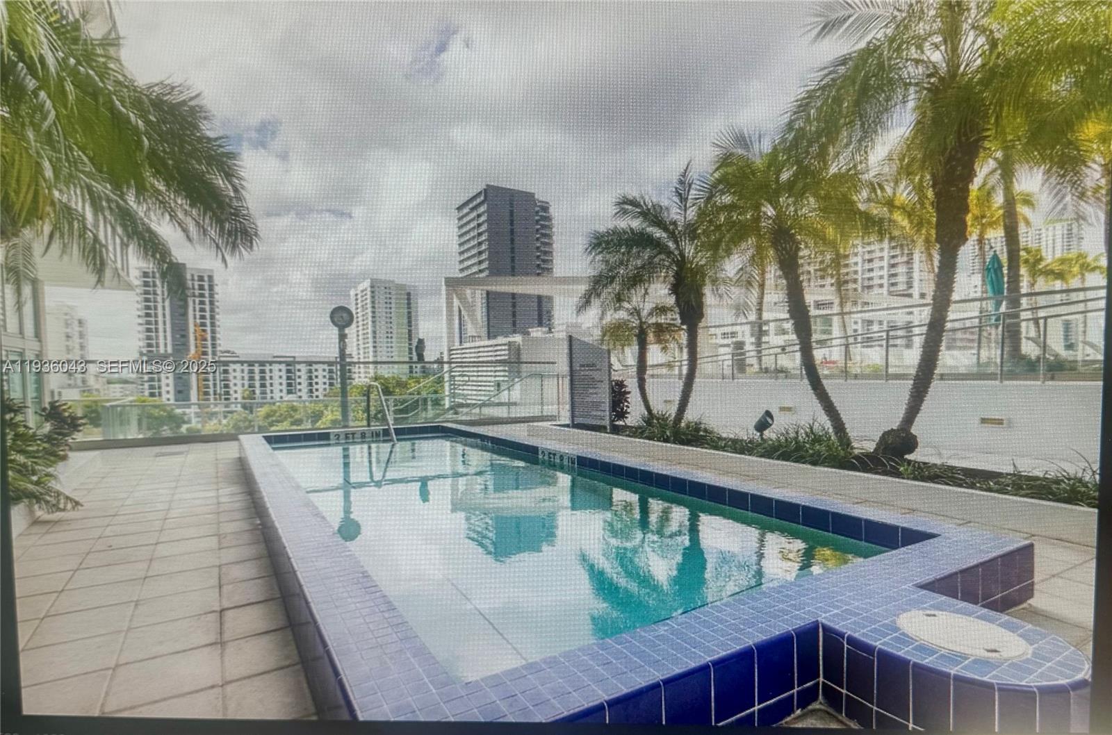 1111 Southwest 1st Street, Unit 2616 Miami, FL 33130 - Photo 2 of 27 a view of a swimming pool with a patio
