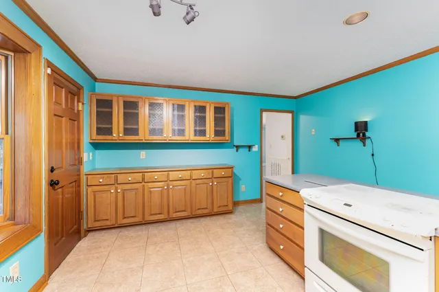 a view of an empty room with a fireplace and a window