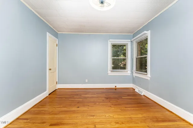 a view of a room with wooden floor