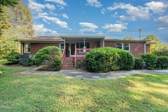 a view of house with yard