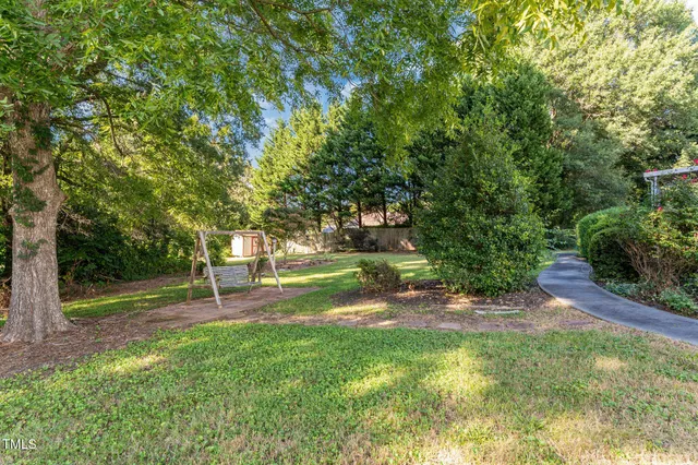 a house view with a swimming pool and garden space