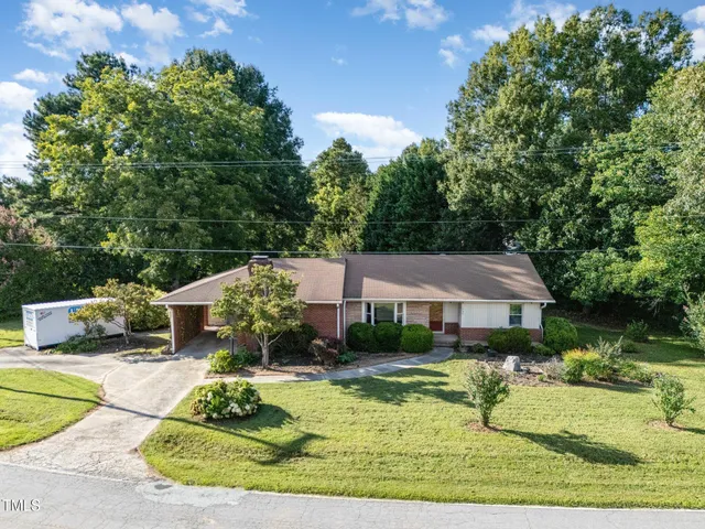 an aerial view of a houses with a yard