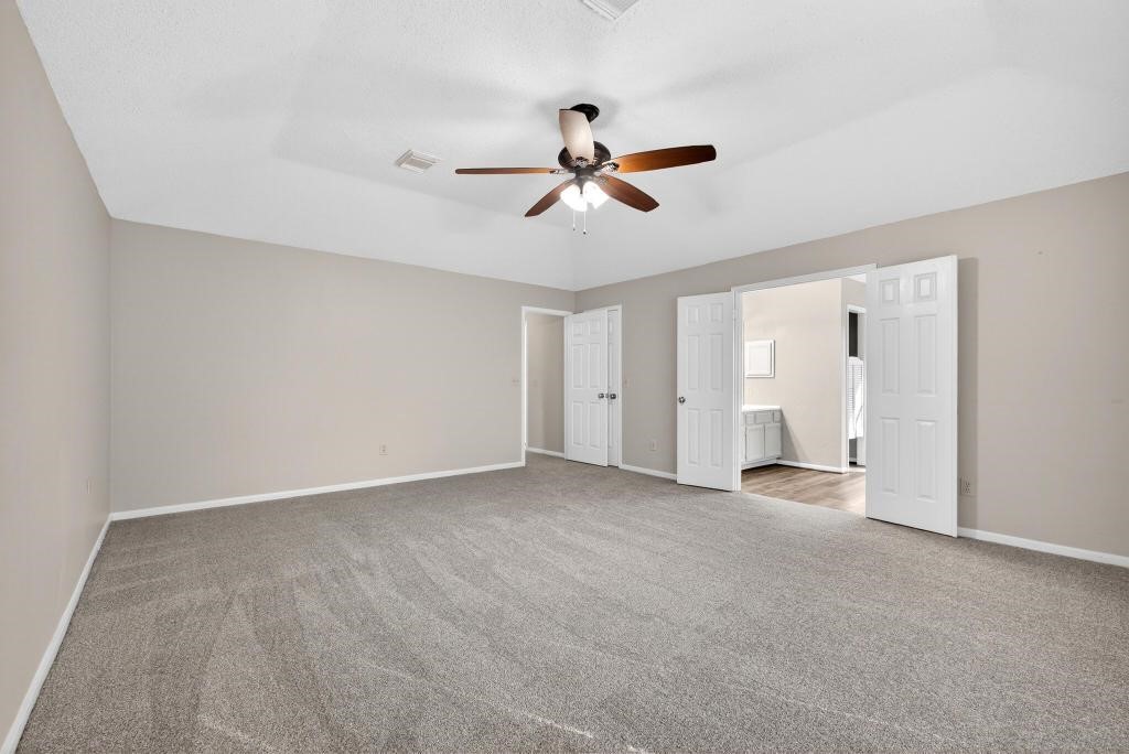 8815 Stoney Bend Drive Spring, TX 77379 - Photo 14 of 50 Spacious, carpeted room with neutral walls, a ceiling fan, and ample natural light.
