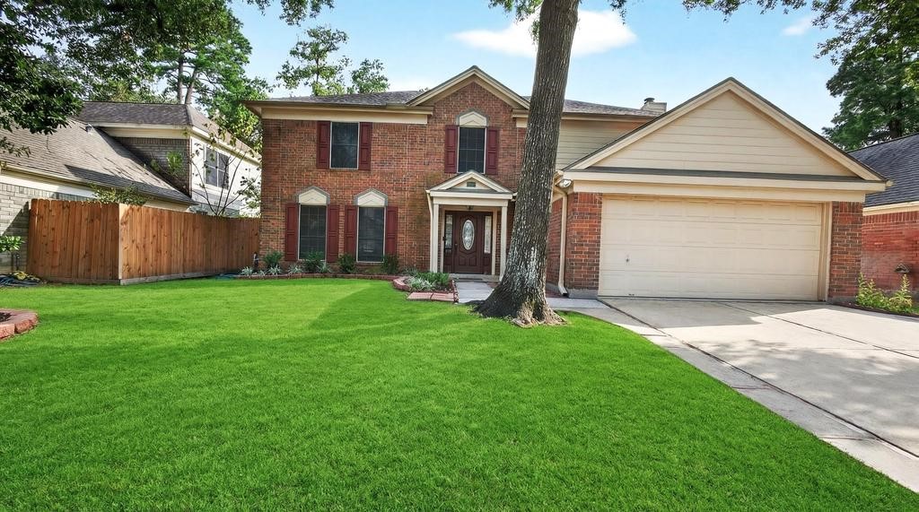8815 Stoney Bend Drive Spring, TX 77379 - Photo 33 of 50 This charming two-story brick home features a well-maintained front yard with lush green grass, mature trees, and a welcoming entrance. The attached two-car garage provides ample parking space, and the property is framed by a wooden privacy fence.