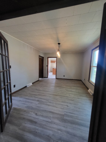 801 Main Street Crescent City, IL 60928 - Photo 5 of 11 a view of an empty room with wooden floor