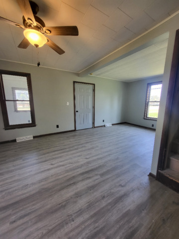801 Main Street Crescent City, IL 60928 - Photo 8 of 11 a view of an empty room with window and wooden floor