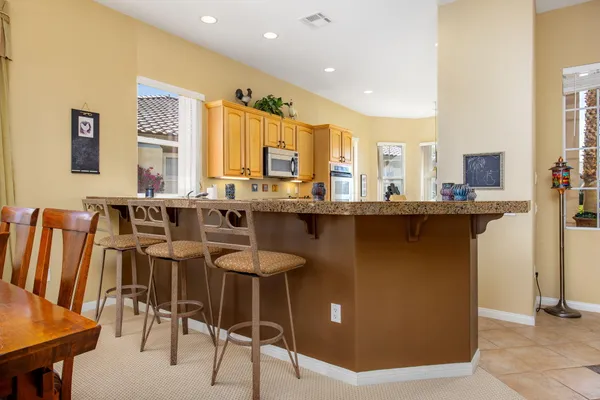 a dining table with chairs and window