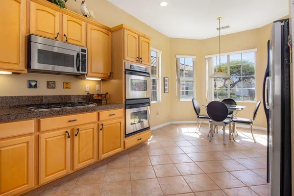 a kitchen with stainless steel appliances a stove a sink and a microwave