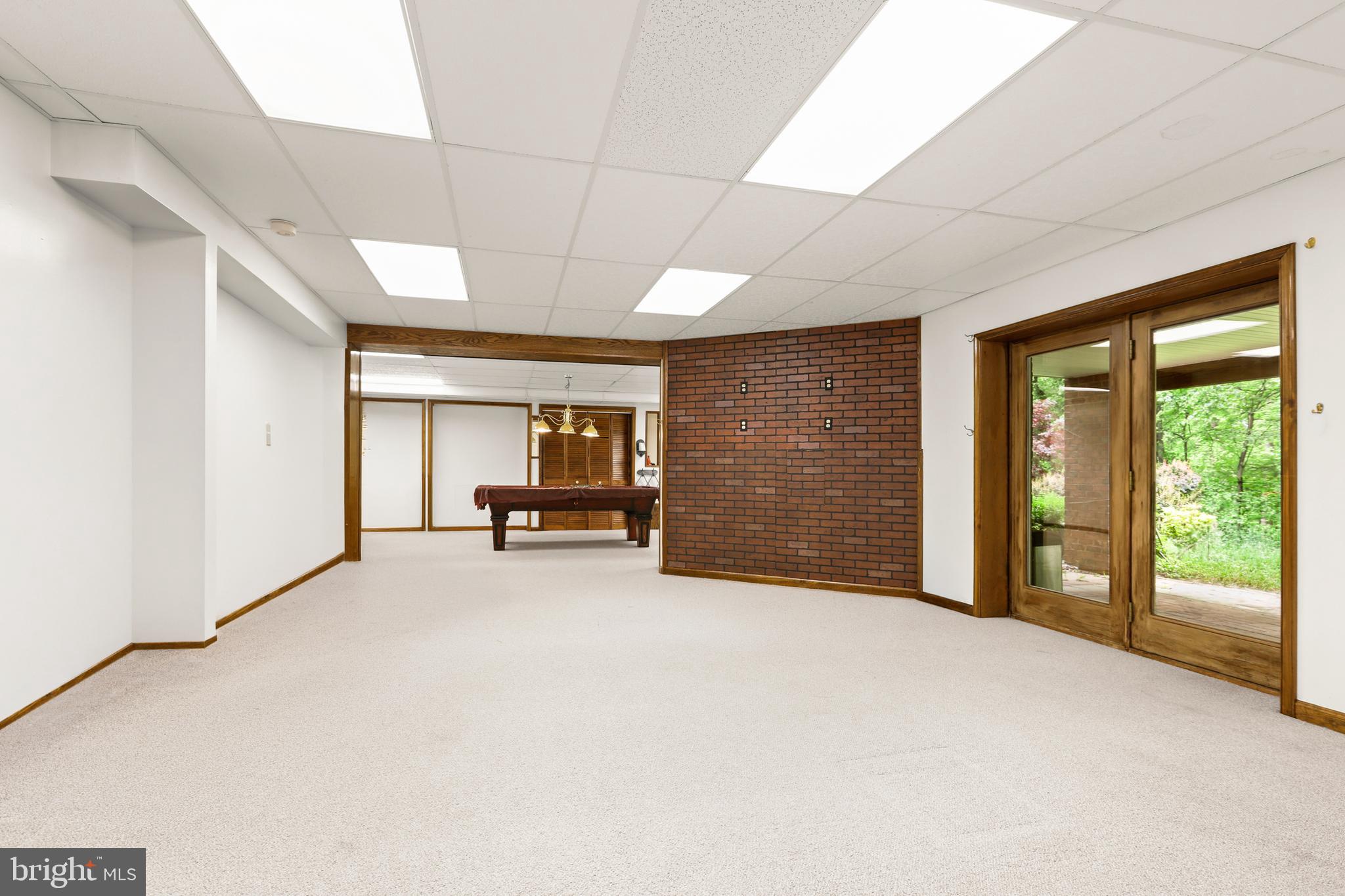 5602 Patterson Road Baldwin, MD 21013 - Photo 80 of 88 LL Rec Room w/ carpet and door to side paver patio