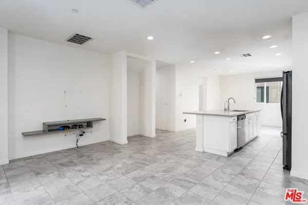 a kitchen with stainless steel appliances granite countertop a stove a microwave and a refrigerator