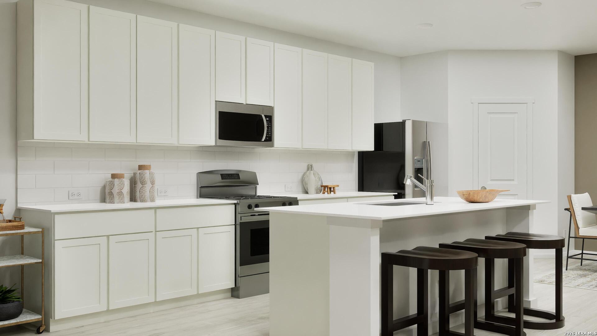 2123 Apollo Drive Portland, TX 78374 - Photo 13 of 32 a kitchen with stainless steel appliances a stove a sink refrigerator and cabinets