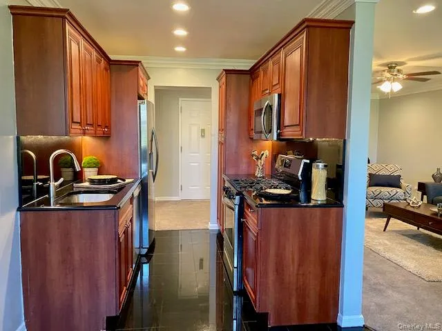 a kitchen with sink and refrigerator