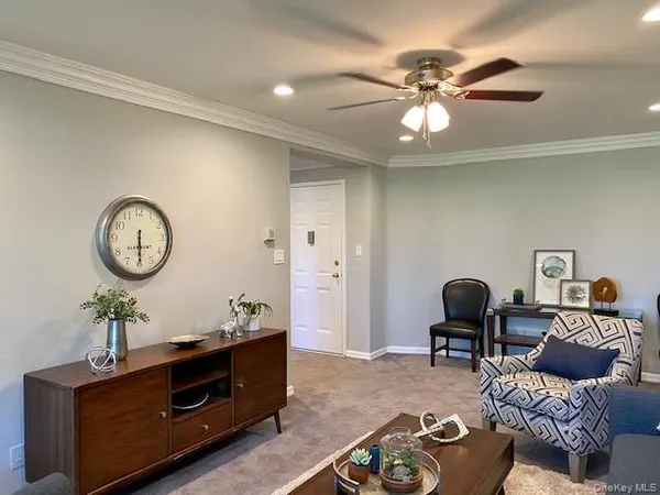 a living room with furniture a rug and decor