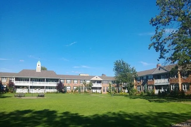 a front view of a building with a garden