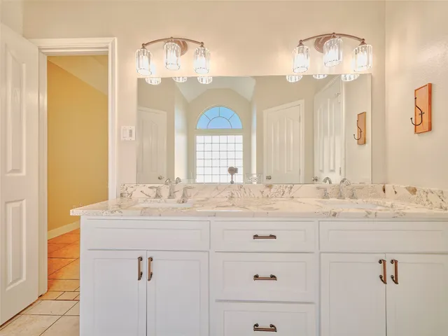 a bathroom with a sink vanity and a mirror