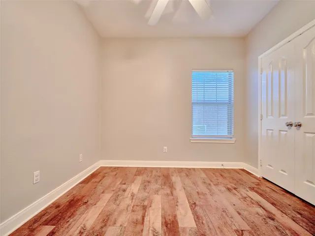 a view of a room with wooden floor and white walls