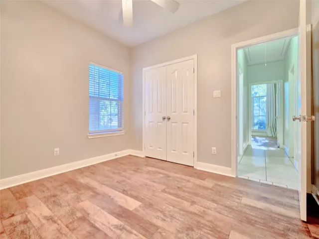 an empty room with window and wooden floor