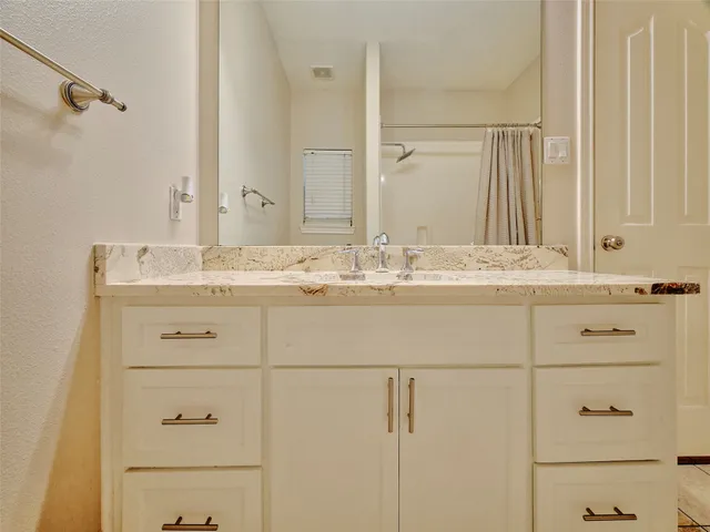 a bathroom with a sink and vanity