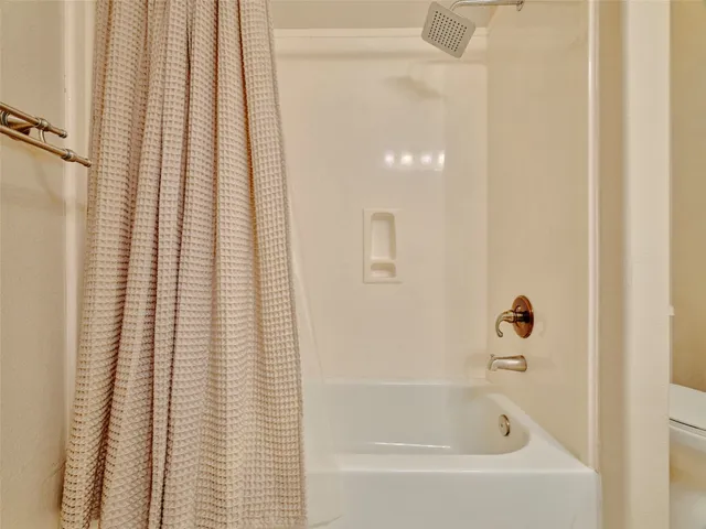 a bathroom with bathtub and shower