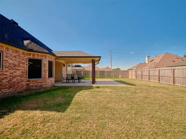 a view of a house with backyard and sitting area