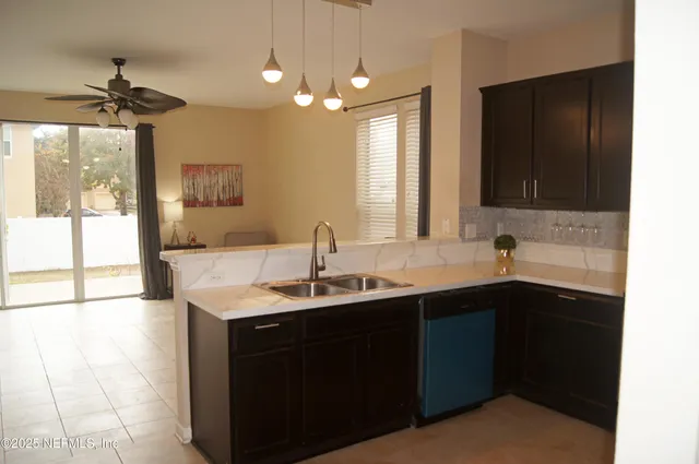 a kitchen with a sink and a wooden cabinets