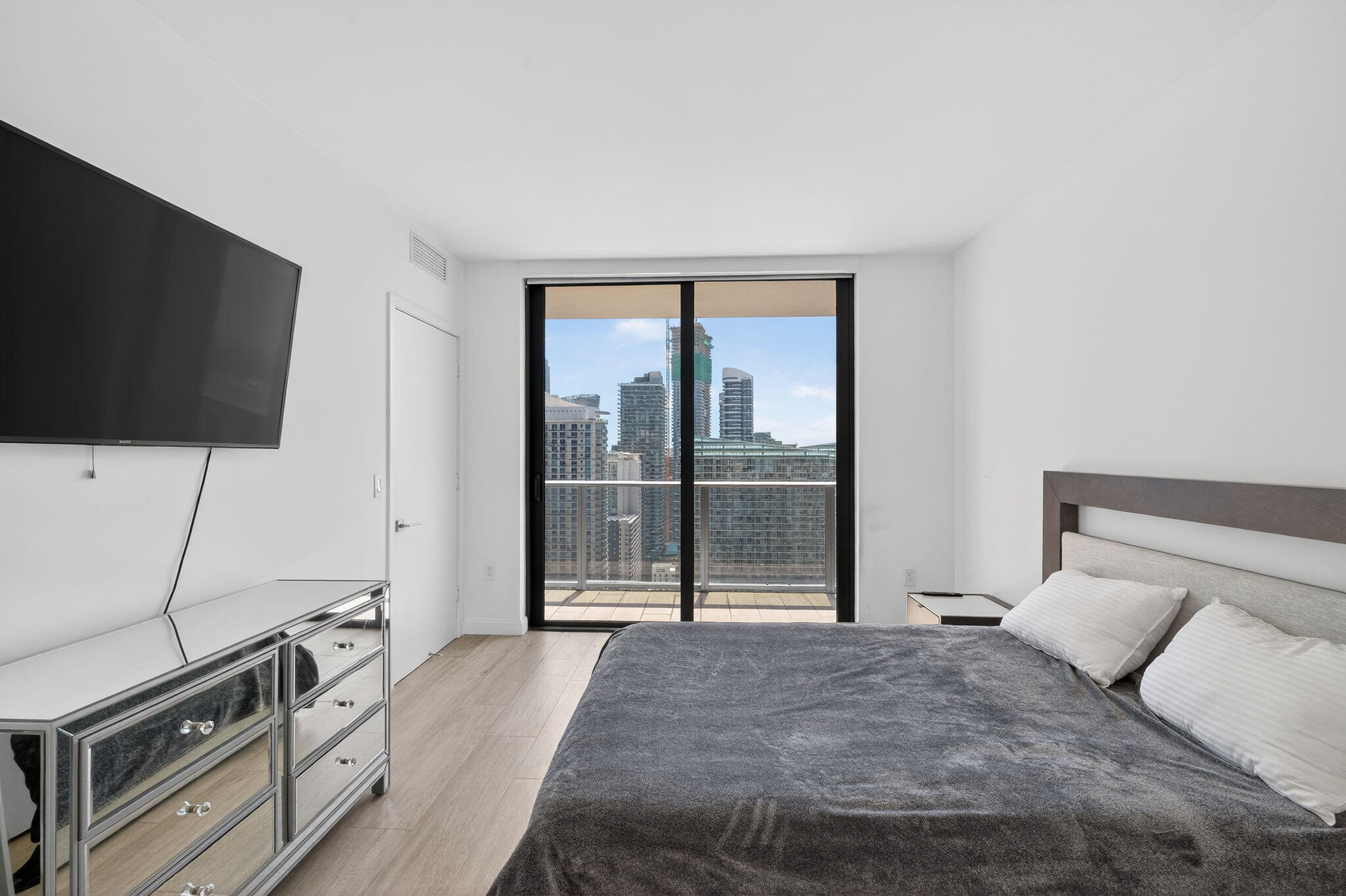 55 Southwest 9th Street, Unit 3704 Miami, FL 33130 - Photo 11 of 53 a bedroom with a bed and a flat screen tv