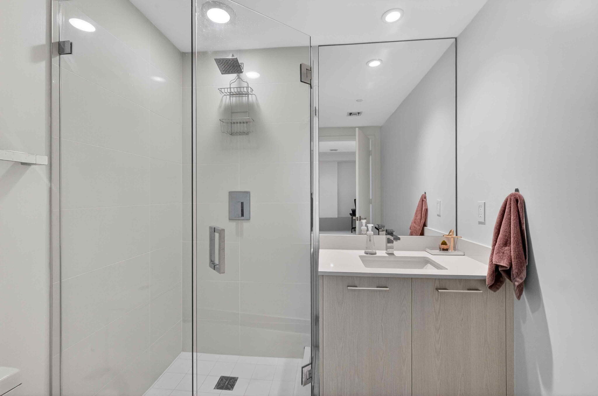 55 Southwest 9th Street, Unit 3704 Miami, FL 33130 - Photo 15 of 53 a bathroom with a double vanity sink a mirror and shower